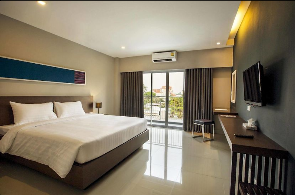 A bedroom with a large glass door  Description automatically generated with low confidence